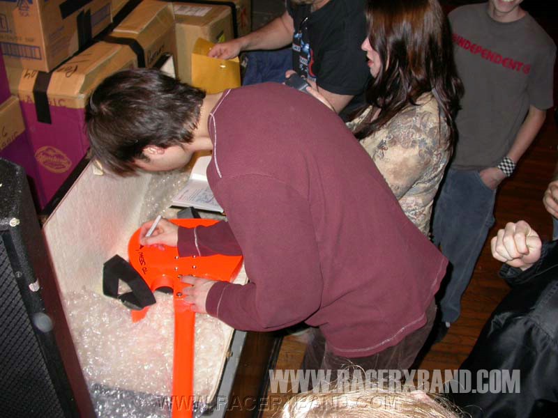 23. Paul signs the XOXO guitar Sean bought.jpg