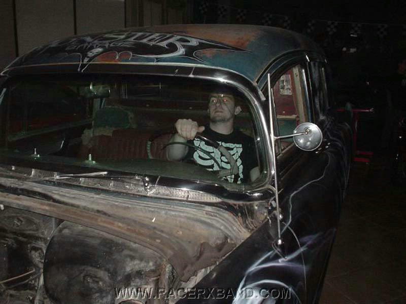 56.  Chad's friend Mike sitting behind the wheel of the hearse..jpg